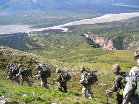 2003 Jeep TJ - Soldiers trek up a mountain trail, with a vast river valley stretching out below them.