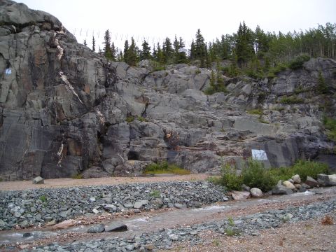 2003 Jeep TJ - A natural scene of a rocky mountainside, trees, and a flowing stream.