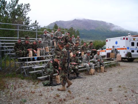 2003 Jeep TJ - An ambulance is visible next to a set of bleachers occupied by soldiers.