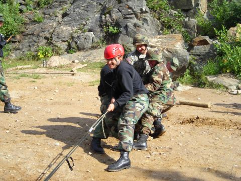 2003 Jeep TJ - Soldiers participate in a training exercise involving a rope and a rocky terrain.