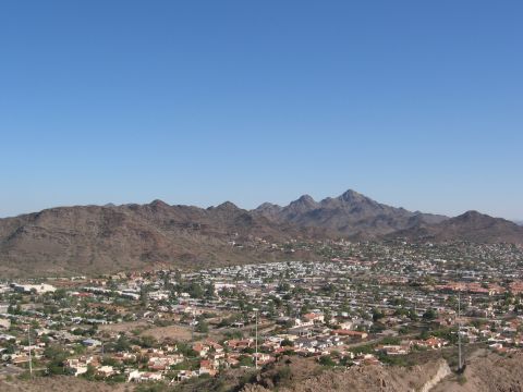 1995 Ford Probe - A wide view of a city spread out below a mountain range on a clear day.