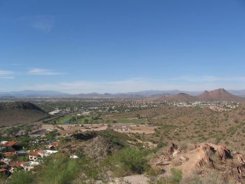 1995 Ford Probe - A wide view of a desert town and surrounding mountains under a bright blue sky.