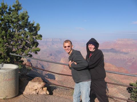 1995 Ford Probe - Two friends enjoy the view from the Grand Canyon, with a tree and a concrete barrier in the foreground.