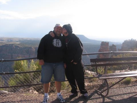 1995 Ford Probe - A father and child share a moment at a scenic overlook, with a vast canyon stretching out behind them.
