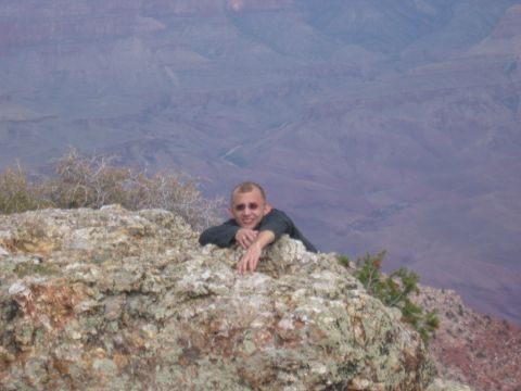 1995 Ford Probe - A man poses on a rocky outcrop with a vast canyon landscape in the background.