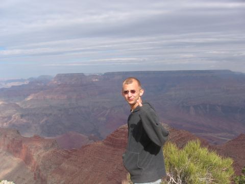 1995 Ford Probe - A person stands at the Grand Canyon, with the Supermotors.net logo visible in the lower right corner.