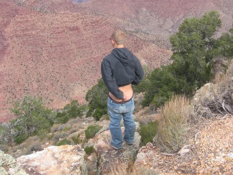 1995 Ford Probe - Man stands on cliff edge at Grand Canyon, looking out over the vast landscape.