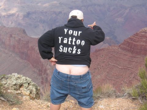 1995 Ford Probe - A man stands at the edge of the Grand Canyon, wearing a hoodie that reads "Your Tattoo Sucks".