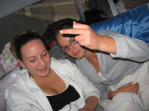 1995 Ford Probe - Two women are inside a vehicle, with one giving the middle finger gesture.