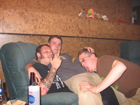 1995 Ford Probe - Three men are seen on a couch in a room with wood-paneled walls.