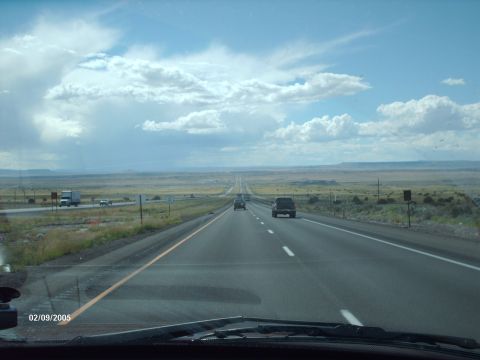 1995 Ford Probe - Long highway drive with several vehicles on a partly cloudy day, dated 02/09/2005.