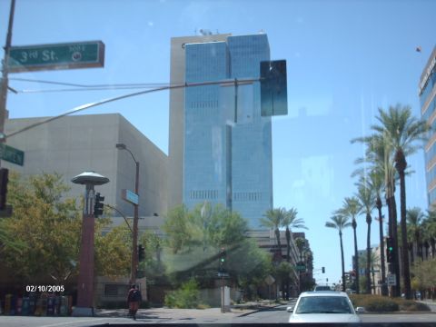 1995 Ford Probe - A view of a city street with a tall glass building and palm trees, dated 02/10/2005.