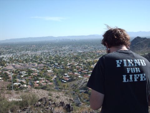 1995 Ford Probe - View of a city from a hilltop, with a person in the foreground wearing a graphic t-shirt.