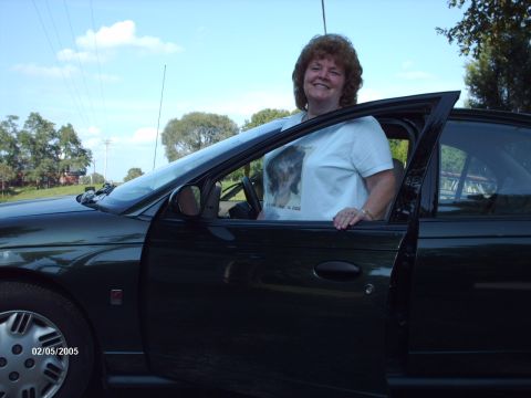 1995 Ford Probe - A woman poses next to a dark green car, with the date 02/05/2005 visible on the wheel.