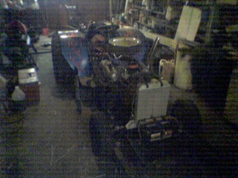1991 Chevrolet Blazer - Engine and associated parts are visible in a cluttered garage setting.