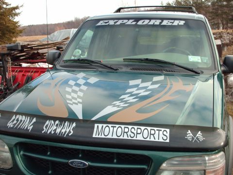 1991 Chevrolet Blazer - Ford Explorer with racing-themed decals on the hood and bug deflector.