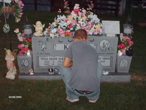 1995 Ford Probe - A person visits a grave adorned with flowers and decorative angels.