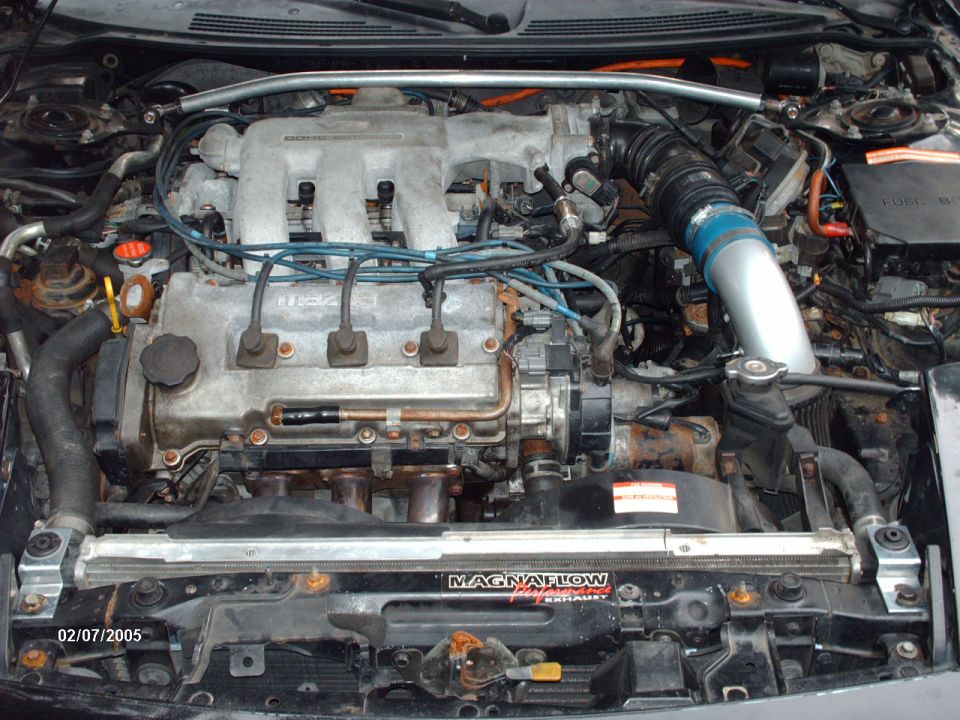 Mazda V6 engine bay with Magnaflow strut bar and intake