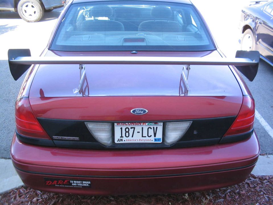 Red 2001 Ford Crown Victoria rear with large spoiler and Wisconsin license plate
