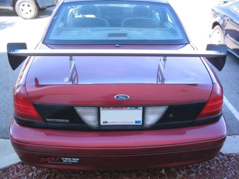 2001 Ford Crown Victoria - This Ford Crown Victoria has a large aftermarket spoiler and a "DARE" sticker on the bumper.
