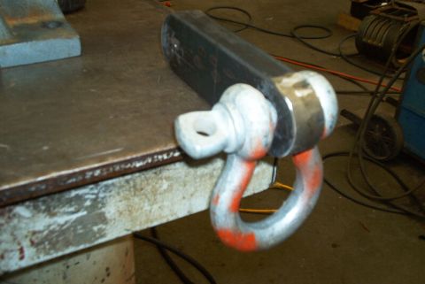 1983 Ford Bronco - A close-up of a tow hitch shackle, likely for recovery or towing, is shown on a metal surface.