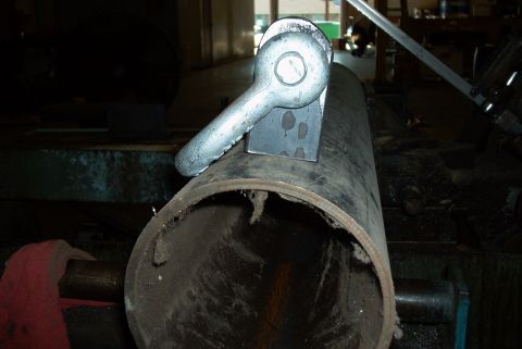 1983 Ford Bronco - Close-up of a metal pipe with a clevis pin and bracket assembly.