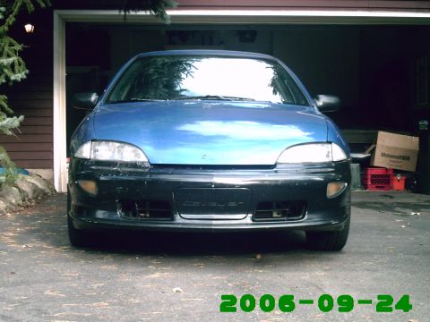 1996 Chevrolet Cavalier - Front view of a blue car with a black bumper that has 'CHEVROLET' text visible.
