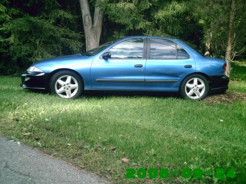 1996 Chevrolet Cavalier - Side view of a blue 1996 Chevrolet Cavalier sedan parked on a grassy area with trees in the background.