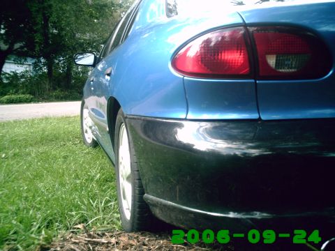 1996 Chevrolet Cavalier - Rear view of a blue sedan with a black bumper and red taillight.