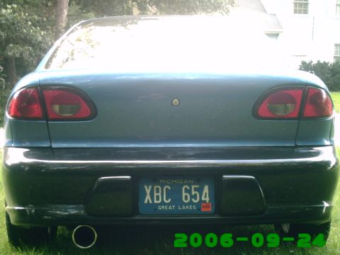 1996 Chevrolet Cavalier - The rear of a blue sedan is shown, a Michigan license plate and a black bumper.