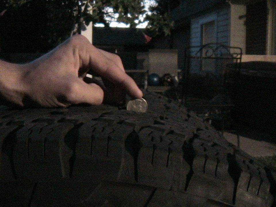 Tire tread depth measured with a quarter