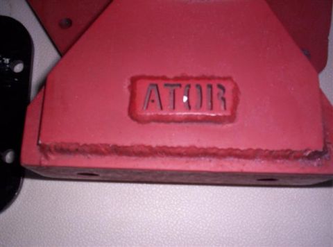 1995 Ford Bronco - Close-up of a red metal component with stamped lettering and weld marks.