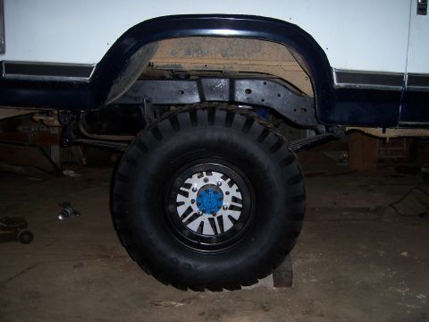 1983 Ford Bronco - Close-up view of a vehicle's off-road tire and suspension components.