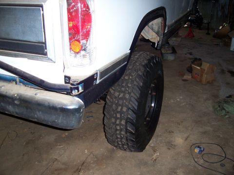 1983 Ford Bronco - Rear view of a 1983 Ford Bronco, showing its large tire and bumper.