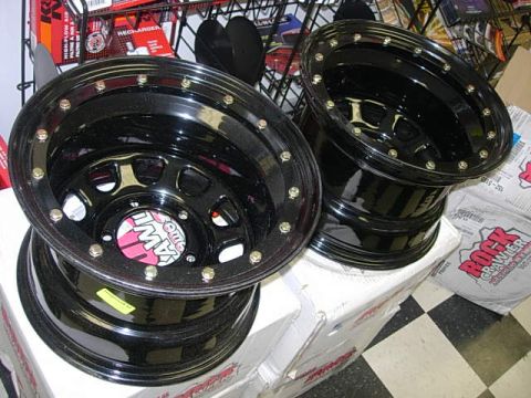 1993 Ford Bronco - Two black off-road wheels are displayed on top of boxes.