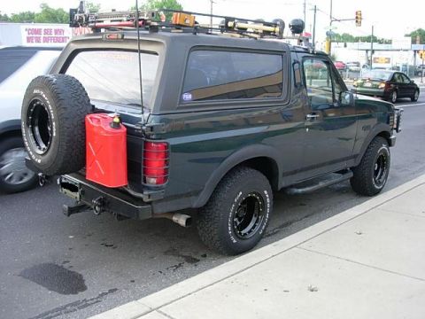 1993 Ford Bronco - This Ford Bronco is equipped with a roof rack and a rear-mounted spare tire, suggesting it's ready for adventure.
