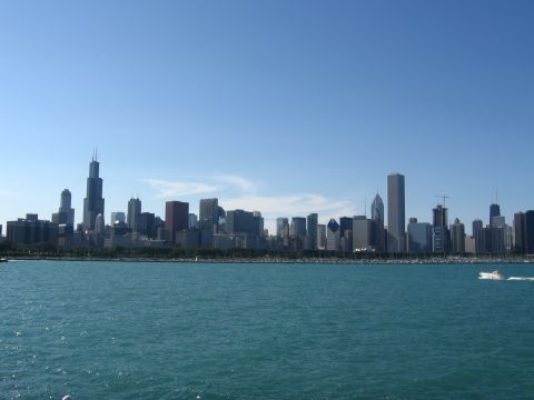 1999 Ford Crown Victoria - A wide view of the Chicago skyline on a sunny day, with a boat sailing on the water.