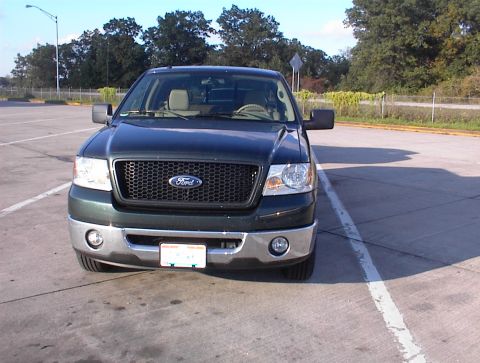 2006 Ford F-150 - 2006 Ford F-150 front view, parked in an outdoor lot with trees in the background.