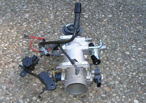 2001 Ford Crown Victoria - Ford throttle body assembly with sensors and wiring, removed from a vehicle.