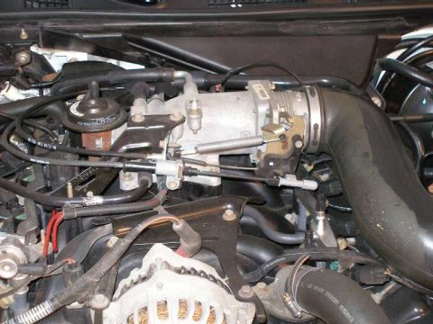 2001 Ford Crown Victoria - Close-up view of engine components, including the throttle body and intake manifold.