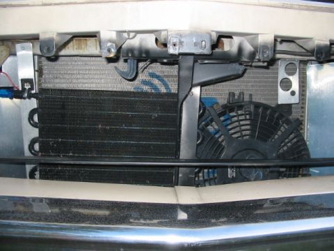 1985 Ford Crown Victoria LTD - The engine bay reveals a radiator, transmission cooler, and electric fan, components vital for vehicle operation.