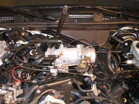 2001 Ford Crown Victoria - Close-up view of the engine bay, focusing on the throttle body and intake manifold assembly.