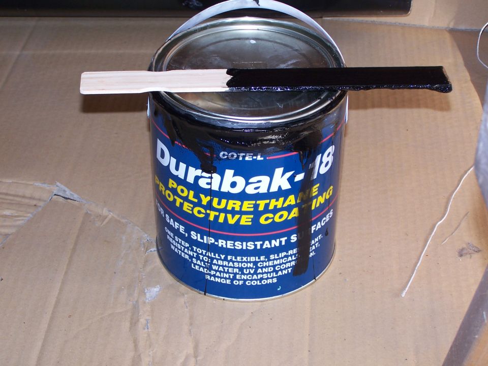 Can of Durabak-18 polyurethane protective coating with a coated stir stick