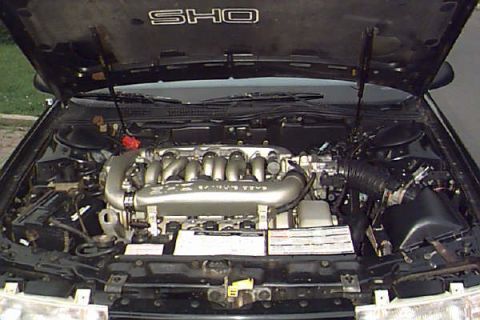 1993 Ford Taurus - Engine bay of a 1993 Ford Taurus SHO, the V6 engine and intake components.