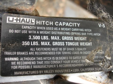 1993 Ford Taurus - This U-Haul hitch capacity plate details weight limits and manufacturer information.