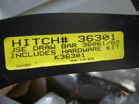 1993 Ford Taurus - Label details a hitch and draw bar kit with part numbers and a date of 04/15/03.