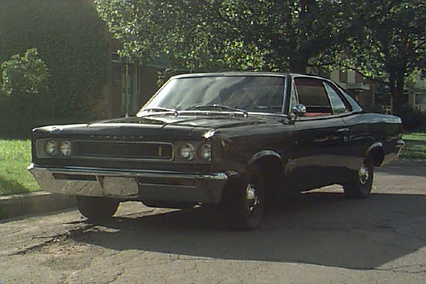 Black 1967 coupe with chrome grille and bumper