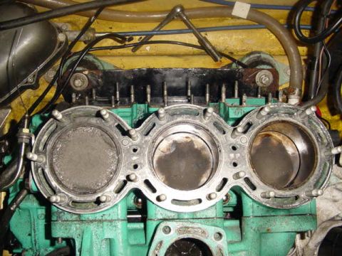 1995 Ford Mustang - Close-up view of an engine block showing pistons and a gasket, with visible wiring and hoses.