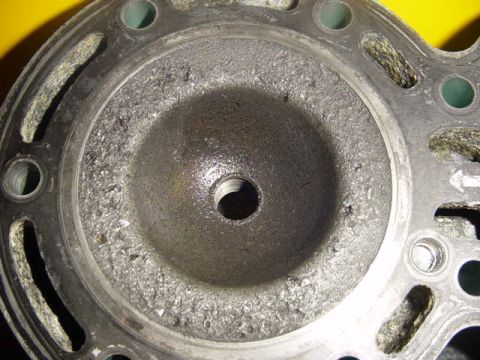 1995 Ford Mustang - This engine cylinder head shows significant damage and wear.