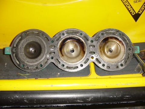 1995 Ford Mustang - Close-up of a used engine cylinder head gasket with visible wear and carbon buildup.